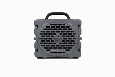 Small gray Turtlebox portable speaker with a handle on a white background