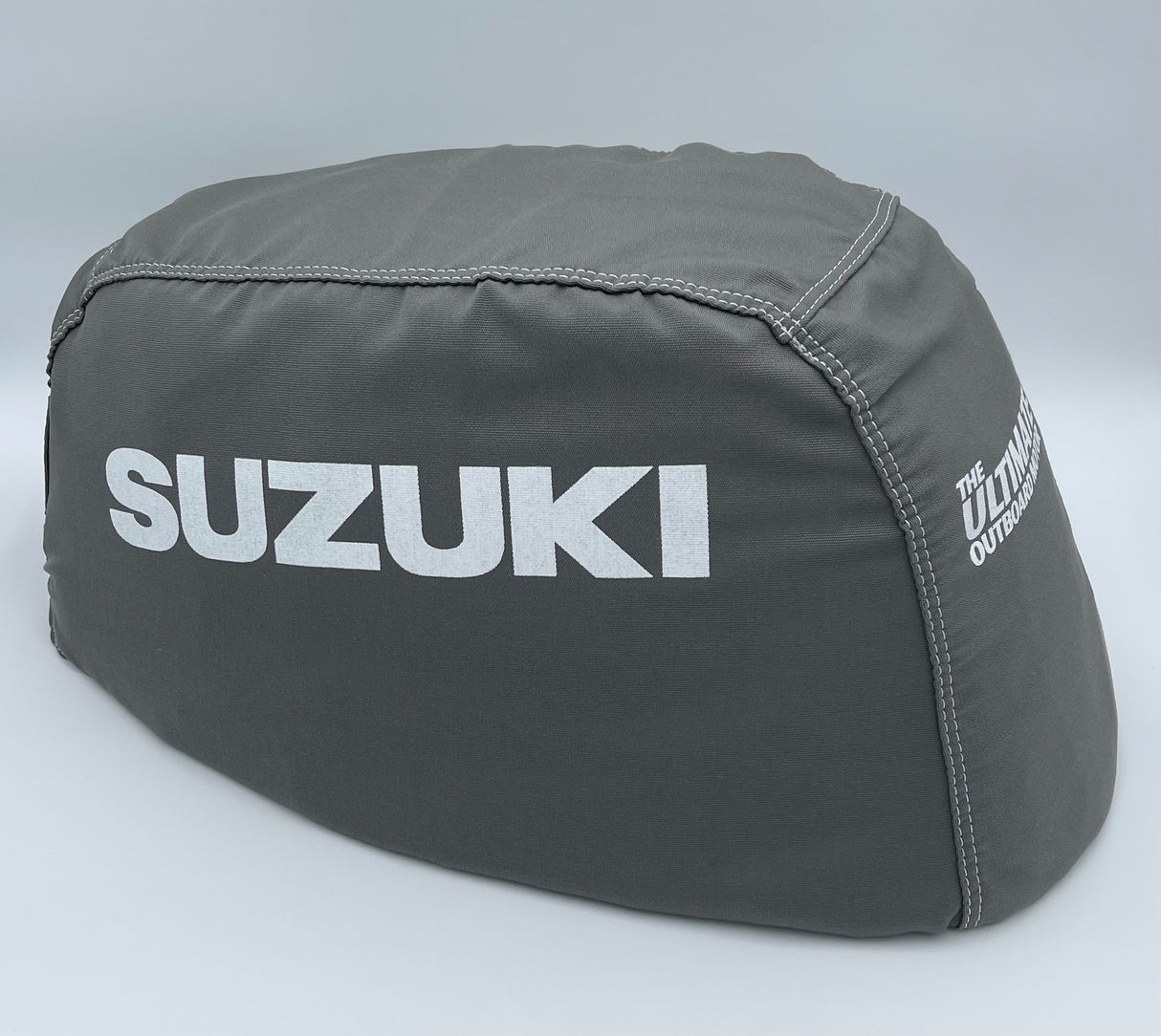 Gray Suzuki outboard motor cover on a light gray background