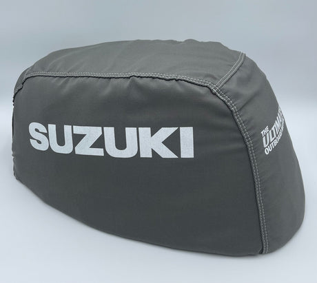 Gray Suzuki outboard motor cover on a light gray background
