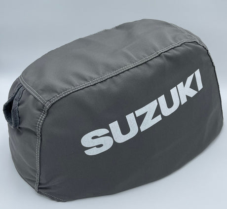Gray Suzuki outboard motor cover on a light gray background
